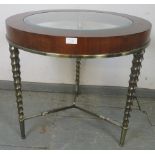A vintage Art Deco style mahogany circular table, with bevelled glass insert, on brass spiral