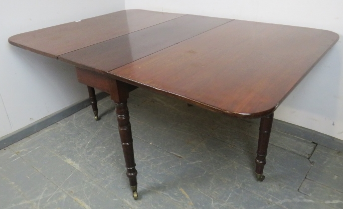 An early Victorian mahogany drop-leaf dining table, on tapering turned supports with brass caps - Image 4 of 4