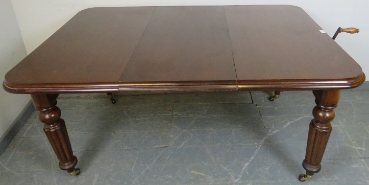 A Victorian mahogany wind-out extending dining table, with additional leaf, on tapering fluted - Image 3 of 4