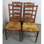 A set of four 19th century oak ladderback dining chairs, with rush seats, on tapering supports