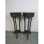 A pair of antique Chinese rosewood two-tier plant stands, the shaped tops with inset red marble,