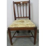 A Georgian oak occasional chair with carved finials and spindles, on tapering square supports with