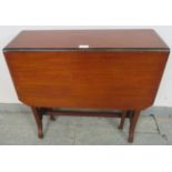 An Edwardian mahogany Sutherland table, with turned spindles to either side, on scrolled supports.