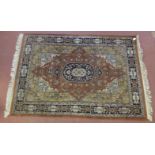 Persian rug, central motif in blues on red ground flower head decorated within multi borders of