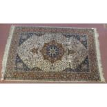 Persian rug Tabriz in browns and beige central motif upon floral panel blue ground corners within
