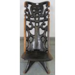 A vintage lignum vitae African birthing stool, with carved and pierced backrest. H76cm W38cm