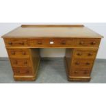 A Victorian mahogany pedestal desk, housing nine graduated drawers with turned wooden knob