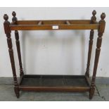 An Edwardian mahogany stick stand, with three divided compartments and lift out tin drip tray,