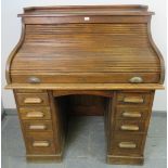 An Edwardian oak ‘S-type’ roll top desk, with ¾ gallery, the fitted interior housing an array of
