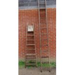 Two vintage ladders; an A frame folding ladder and a tall oak wall ladder. Tallest measures 330cm (