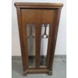 A vintage oak lectern in the Gothic Revival taste, with carved and pierced front, on chamfered