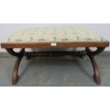 A substantial Victorian rosewood ‘X-frame’ stool, upholstered in tapestry material, on curved