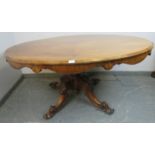 A Victorian walnut oval breakfast table, the quarter veneered top with shaped frieze, on a bulbous