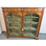 A good quality Georgian Revival low glazed bookcase, with crossbanded inlay and shell carved