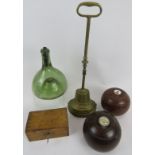 Two vintage Lignum Vitae presentation lawn bowls, a vintage wooden money box and key, a brass lead