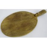 Robert 'Mouseman' Thompson carved oak cheese board, oval form with handle, signature carved mouse,