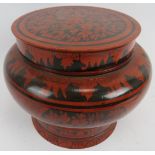 A large Indo Persian red lacquered covered pot of baluster form with black hand decoration.