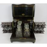 A 19th century brass, inlaid ebonised decanter box, the hinged lid and side panels opening to reveal