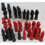 A large red and black Zoomorphic chess set, moulded, 20th century, King 19cm high. Condition rep[