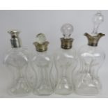 Three Hukin & Heath Arts and Crafts silver mounted glass decanters, with stoppers (stoppers may