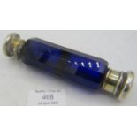 A double ended blue glass scent/smelling salts bottle with white metal tops. Condition report: One