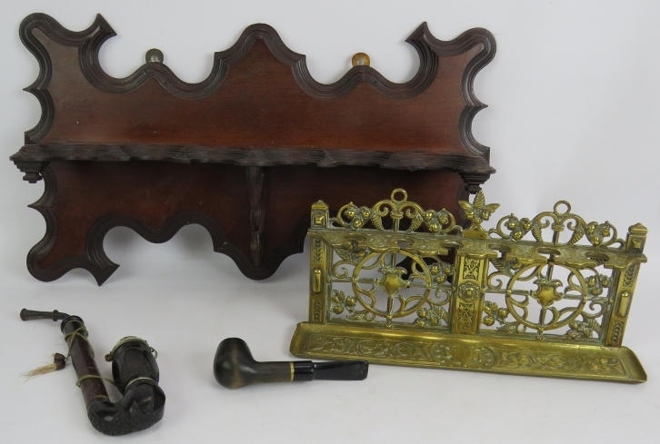 An ornate Edwardian mahogany pipe rack, a cast brass aesthetic movement pipe rack and two tobacco