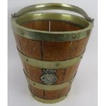 A metal banded oak bucket, 19th century. Swing handled with two crowned monogramed appliques, 12.