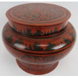A large Indo Persian red lacquered covered pot. Of baluster form with black hand painted decoration.