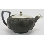 A rare Wedgwood basalt stoneware teapot with silver mounts, circa 1820. Modelled with an angular