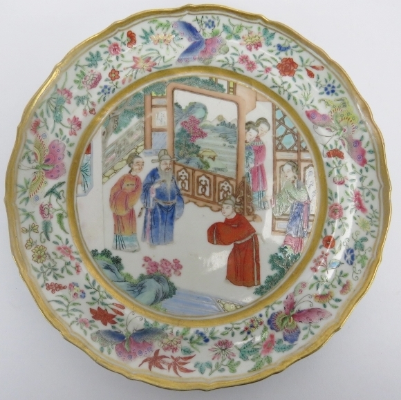 A Chinese famille rose plate, circa 1820. Finely painted depicting figures in an interior with a