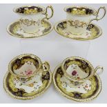 A set of four porcelain cups and saucers, 19th century. With lavish gilt trim, blue borders and