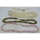 A multi stranded natural Keishi pearl necklace comprising of 10 strands joined together on a white