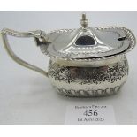 A silver mustard pot with half fluting and engraved decoration. Sheffield 1895, silver weight: 2.7