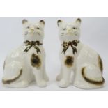 A pair of Staffordshire ceramic cats, late 19th century or later. Both hand painted with lustre