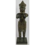 A large Cambodian bronzed metal figure of Buddha, Angkor style, 20th century. Cast in full length.