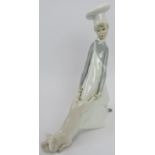 A Lladro porcelain group. Depicting a young chef wrestling with a pig. 9.8 in (25 cm) height.