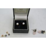 A pair of pearl earrings with 14ct yellow gold backs. Each pearl approx: 5mm x 5mm. Boxed. 1 gram.