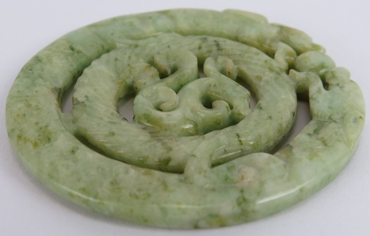 A Chinese carved black speckled celadon Jade disc, Ming style but likely Qing, 7cm diameter. - Image 3 of 3