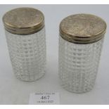 A pair of Victorian cut glass silver topped jars. The silver lids having engraved decoration and