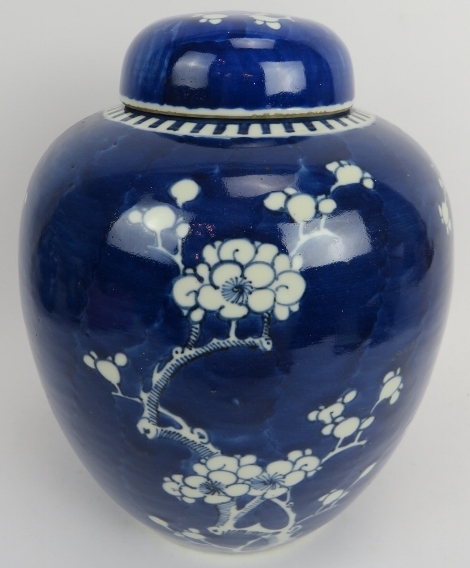 A large Chinese blue and white jar and cover, 19th century. Of ovoid form, decorated with blossoming