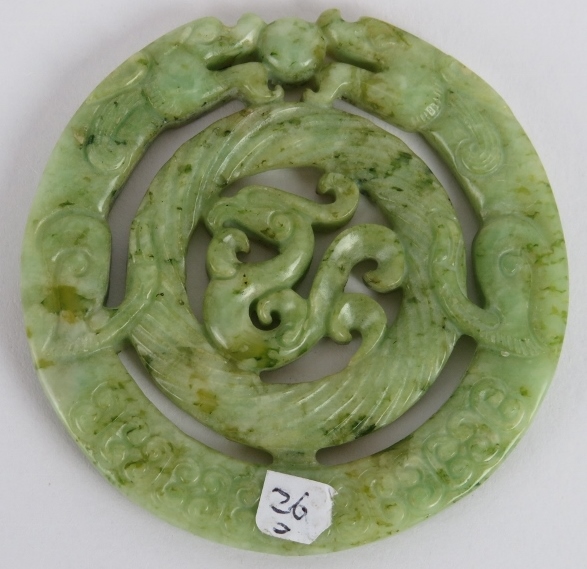 A Chinese carved black speckled celadon Jade disc, Ming style but likely Qing, 7cm diameter. - Image 2 of 3