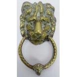 A large cast brass lion mask door knocker, late 19th/early 20th century. More recent screw applied