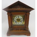 Junghans mantle clock. Architectural oak case, coil strike, with key included. Bevelled glazed