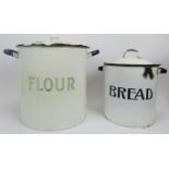 Two large vintage enamelled metal kitchen canisters with covers. Both of cylindrical form with