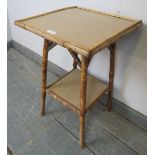 A turn of the century Colonial tiger bamboo two-tier occasional table, on canted supports. H59cm