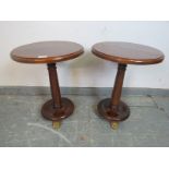 A pair of Regency Revival mahogany pedestal side tables, on tapering columns with plinth bases and