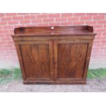 A 19th century rosewood low enclosed bookcase with ¾ gallery, the panelled doors opening onto two