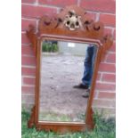 A Georgian mahogany parcel gilt wall mirror in a shaped surround with carved eagle cornice. H91cm