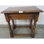 A reproduction oak joint stool in the 18th century taste, on baluster turned supports with