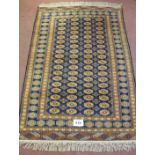 A 20th century Persian design rug, central repeat pattern on blue ground, orange cream and red